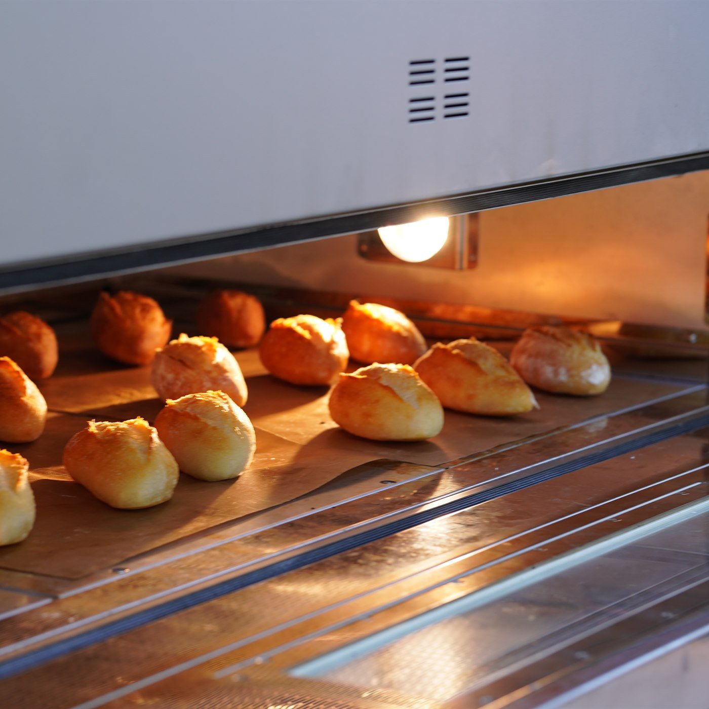 Bread baking inside a commercial oven for hotel and catering production